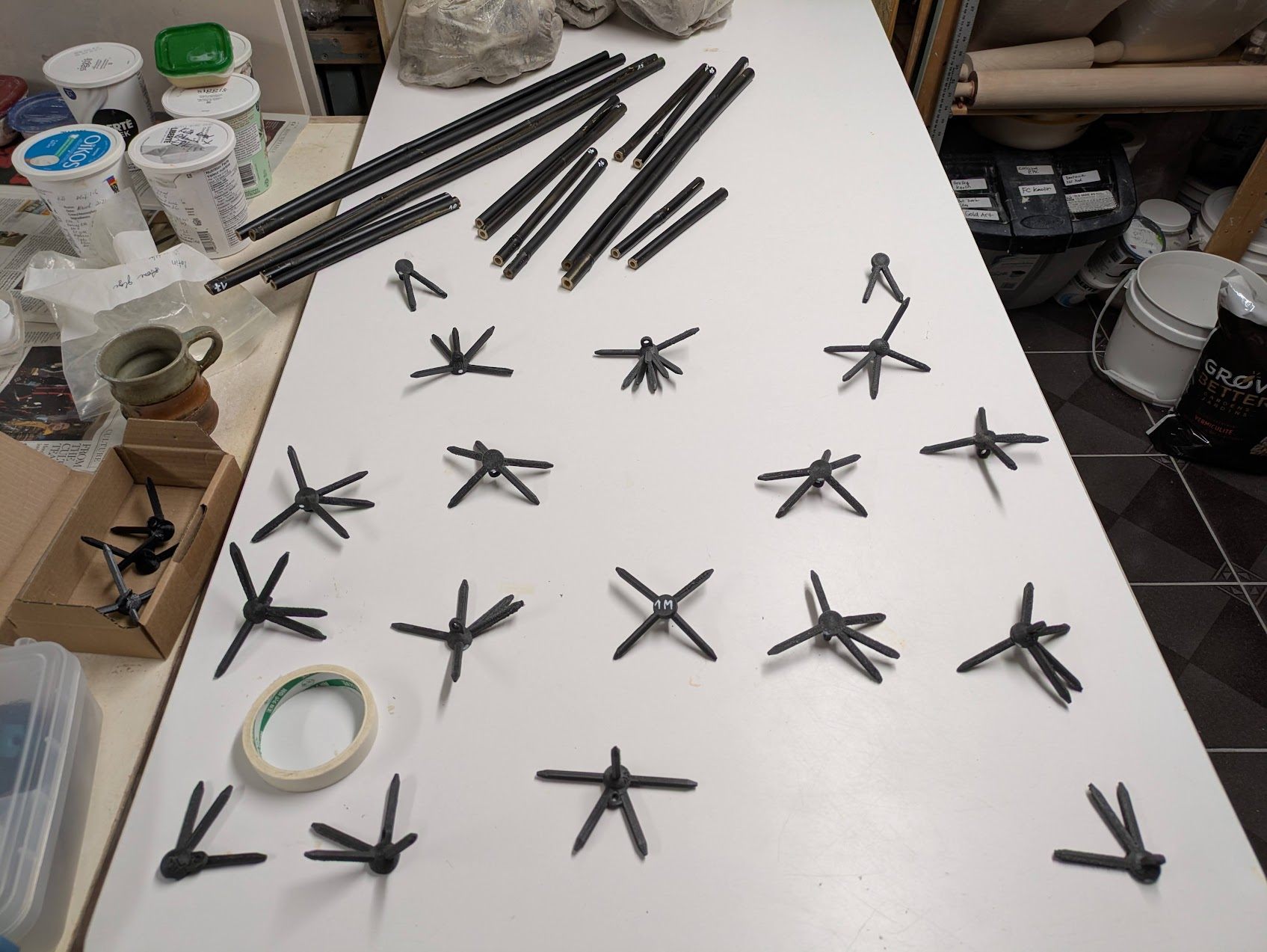 Tubing and 3D-printed star-shaped connectors laid out across a workbench before assembly.