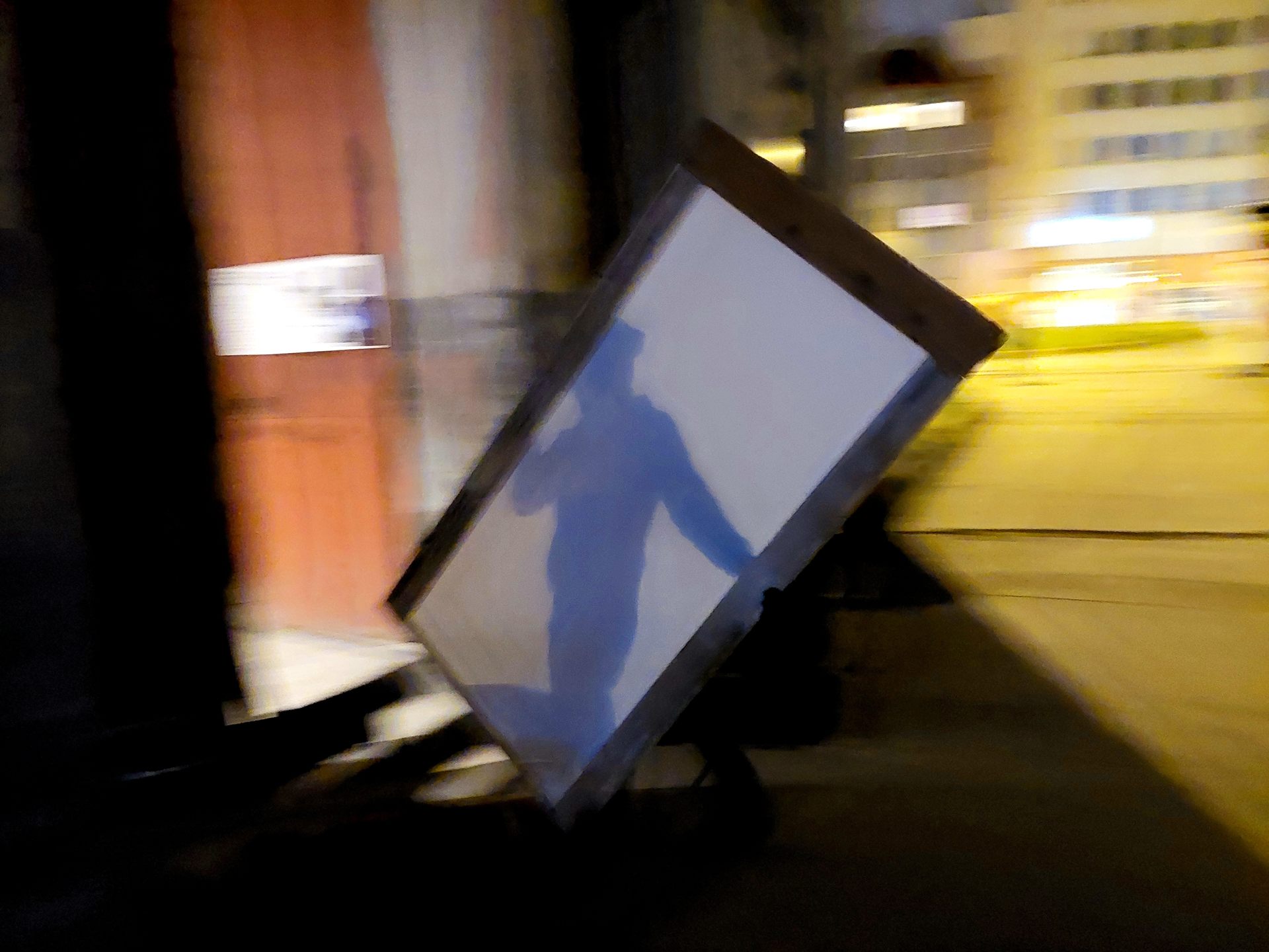 One of the doors being wheeled away on a trolley at the end of the night.