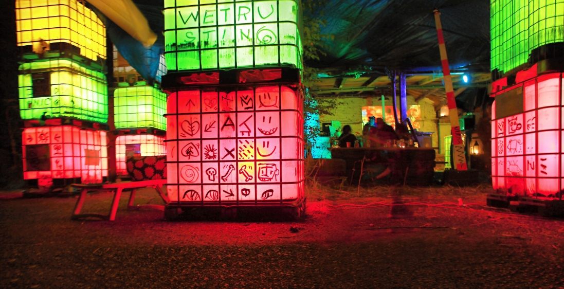 Interior view of the columns of lit containers, each panel marked with a painted symbol.