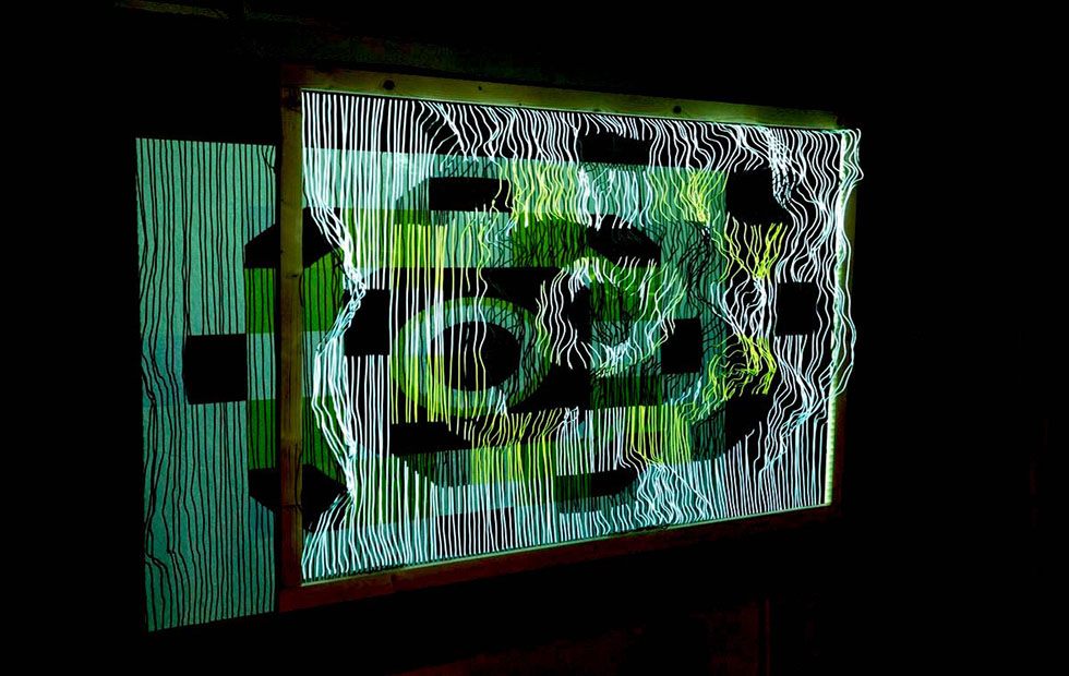 The relief mapped in green, dark circular forms moving across the wires.