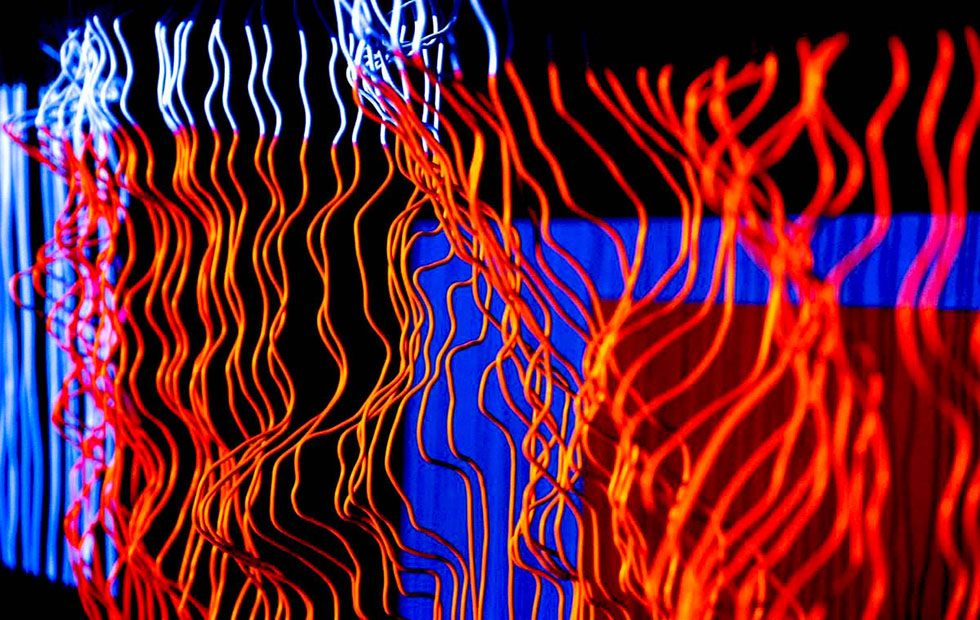 Close view of the wires lit in red and blue, the strands curling away from the frame.