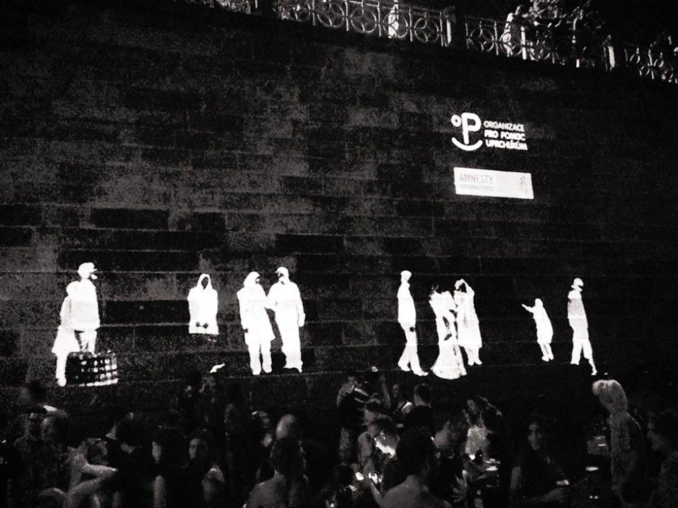 A row of projected figures along the wall with the Amnesty International logo alongside.